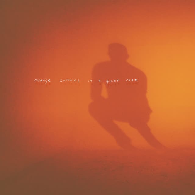 orange curtains in a quiet room - Adam Bokesch